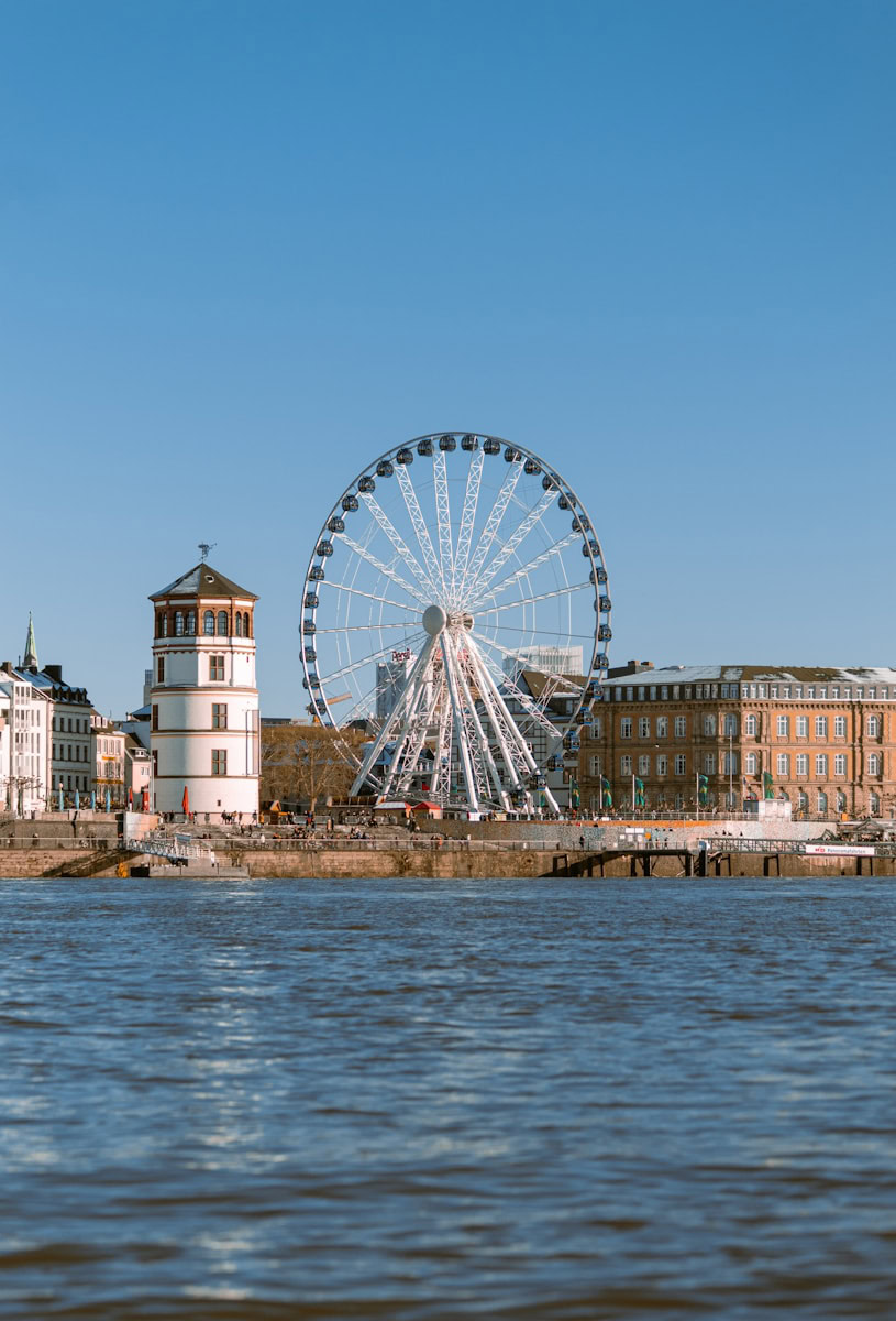 ferris wheel near body of water during daytime